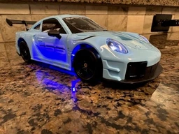 Дрифт машинка кар радиоуправляемая игрушка RC детский автомобиль на пульте управления с USB зарядкой трюковая гоночная скоростная маневренная с светом передними фарами для дома улицы игр дрифтинга бокового скольжения поворотов 360° porsche 1:24 голубой фото от покупателей 4