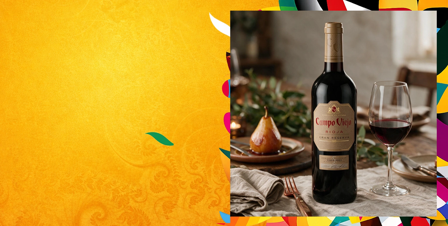 Бутылка Campo Viejo Rioja Gran Reserva и бокал красного вина на сервированном столе