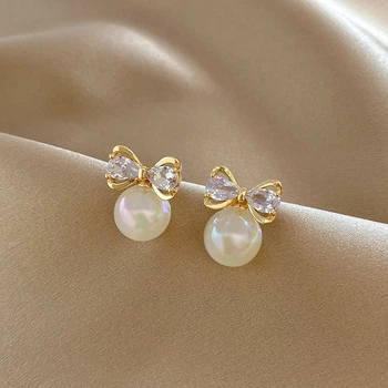 Серьги-гвоздики с жемчужинами и бантиками гвоздики Honey Fashion Accessories перламутровый+золотистый (12-200)