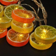 Светодиодная новогодняя гирлянда "Фрукты" 12 LED, 5м + переходник, 220V, IP44, Теплый белый - изображение 4