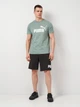 Футболка хлопковая длинная мужская Puma Ess 2 Color No. 1 Logo Tee 68470830 S Green Moon с принтом (4067983326097) - изображение 3