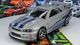 Набір Тематична Машинка Hot Wheels Mitsubishi 1995 Mitsubishi Eclipse Brian O'Conner Fast & Furious 1:64 JBY29 Green + Toyota Supra Brian O'Conner Orange + Nissan Skyline GT-R (BNR34) Brian O'Conner Silver + 1970 Ford Escort RS1600 Brian O'Conner Blue + - зображення 4
