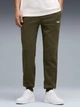 Спортивные штаны мужские утепленные Puma Essentials Graphics 68471370 S Dark Olive (4069157449618) - изображение 1