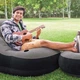 Надувное кресло Intex 68564-2 из ПВХ 130х99х76 см с круглым пуфом 64х28 см ручным насосом и подушкой Серый (127-9-68564-2) - изображение 7