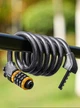 Замок для велосипеда тросовый 1.5 м велозамок стальной на велосипед кодовый спиральный с креплением на раму с холдером противоугонный для велосипеда самоката мотоцикла коляски универсальный WEST BIKING Черный 73570 - изображение 8