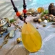 Великий кулон на плетеному шнурку натуральний камінь жовтий агат - зображення 1