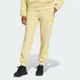Жіночі спортивні штани adidas Z.N.E. adidas JJ4770 (S) жовтий (4067905021826) - зображення 1