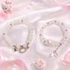 Парные браслеты Hello Kitty белый и серебристый с бусинами 8 мм на резинке, акрил + бижутерный сплав - изображение 9