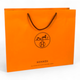 Пакет Hermes 42х14х30 см из плотной бумаги, оранжевый фирменный пакет с черными веревочными ручками - изображение 4