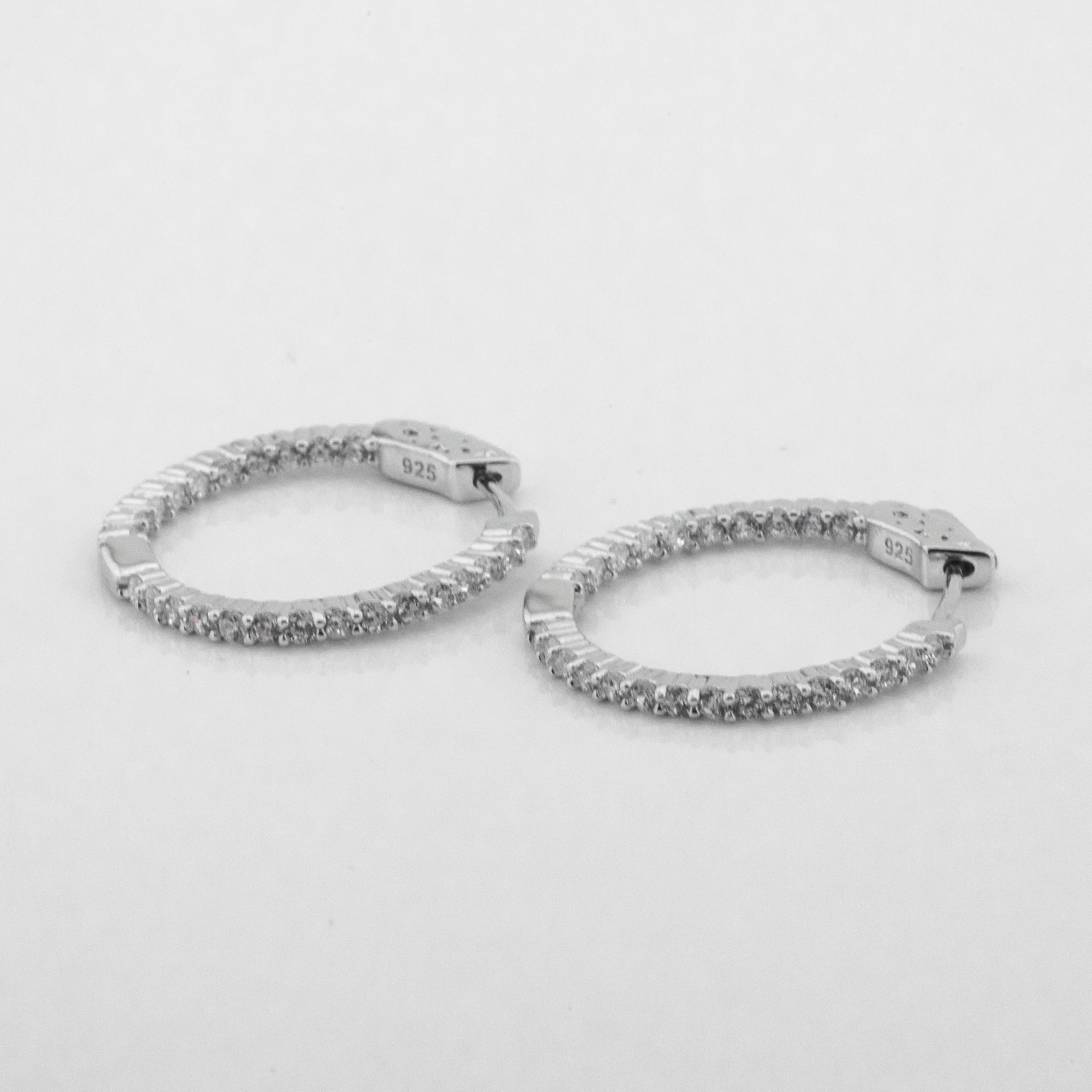 

Серебряные серьги-кольца с фианитами c121551 Диамант