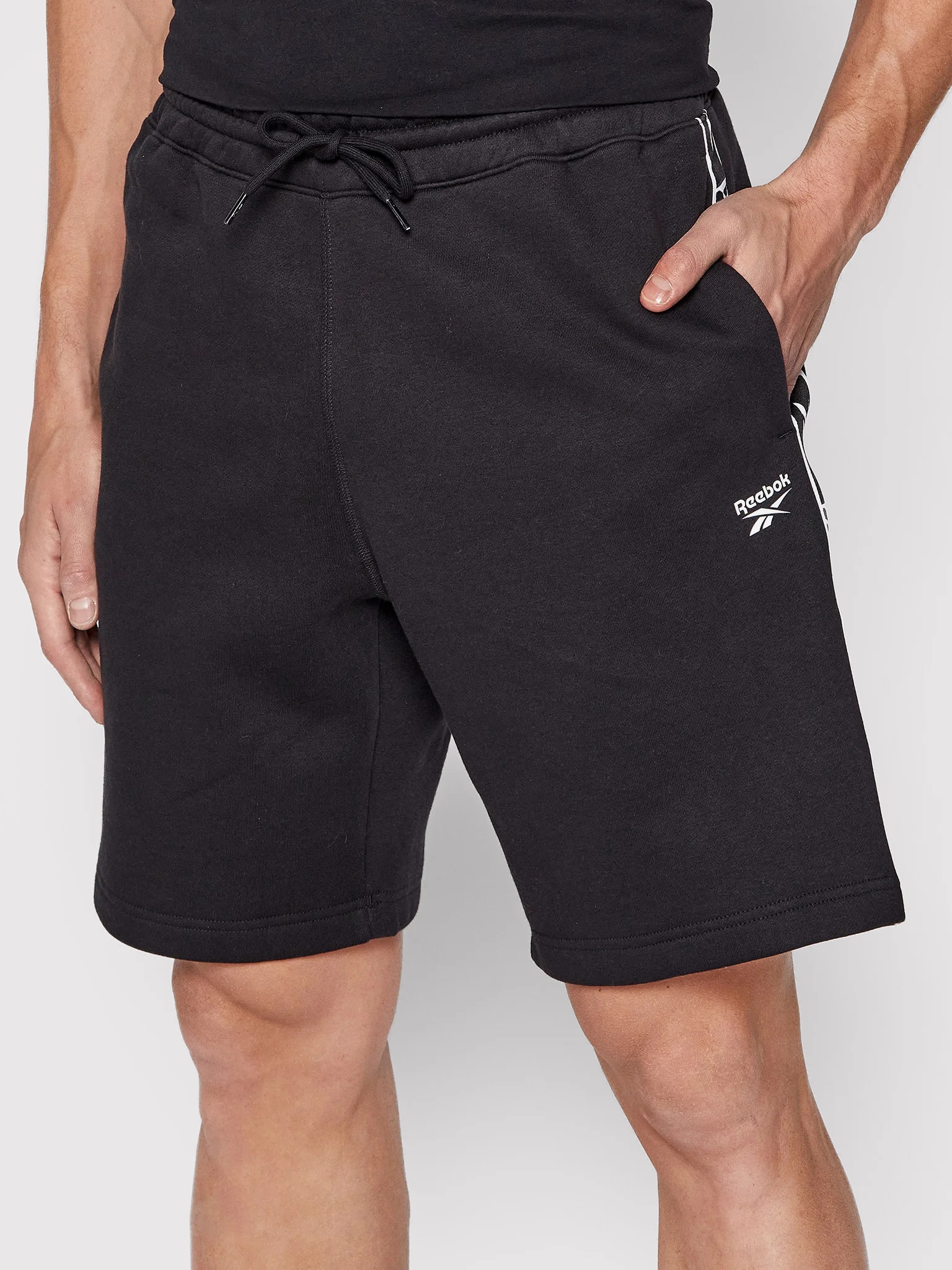 Акція на Шорти бавовняні довгі чоловічі Reebok Ri Tape Short HB5979 L Чорні від Rozetka